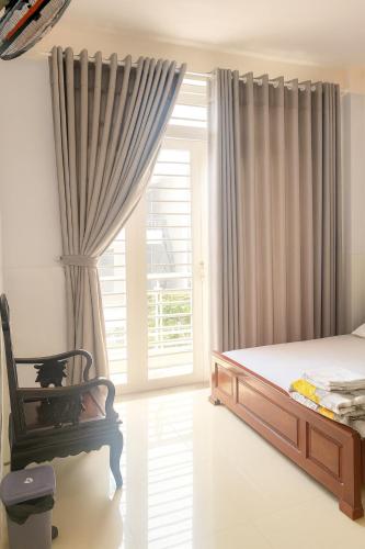 a bedroom with a bed and a window at Kathy Hotel in Ho Chi Minh City