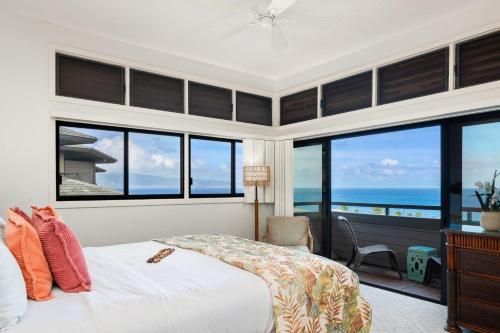 a bedroom with a bed and a view of the ocean at Kapalua Ridge Villas 1011 · KRV 1011 Oceanview Condo + Golf + Lu in Kahana
