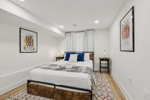 a bedroom with a large bed with blue pillows at City Hopper! in Washington