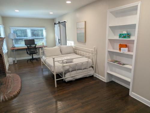 a living room with a couch and a desk at Peaceful North Durham Retreat, 3Bd in Durham