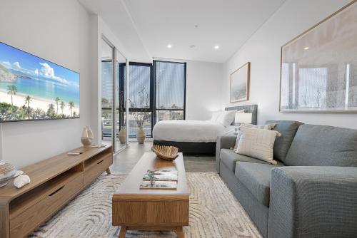 a living room with a couch and a bed at Stylish Studio Near Fremantle Cafés and Beaches in North Fremantle