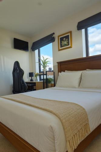 a bedroom with a large white bed and a window at Stonebrook Haven - AC Room, Dedicated Bath, Free Parking in Family House in Rolleston