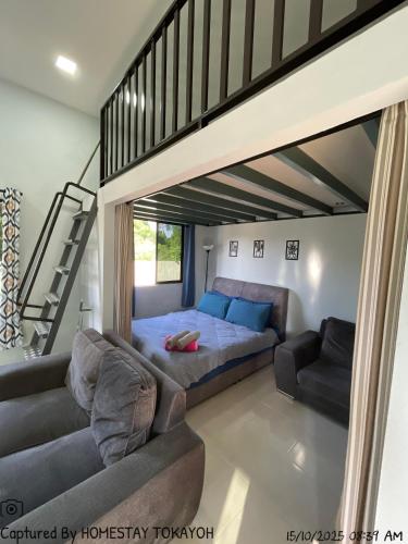 a living room with a bed and a couch at Homestay Studio TOKAYOH in Kota Bharu