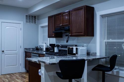 a kitchen with a counter top with a microwave at Modern 3BR Walk to Subway 2 Min to LOGAN Airport in Boston