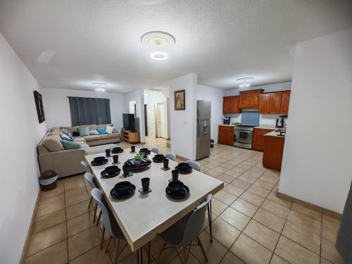a kitchen and living room with a table and chairs at Comfortable 3 bedroom house in Ensenada