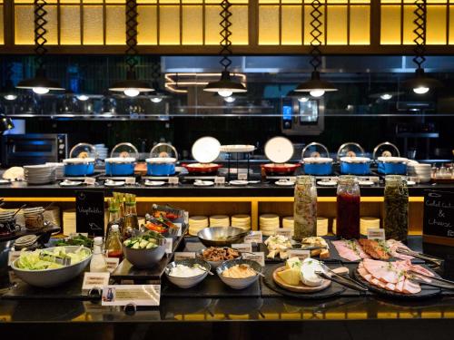 una línea de buffet con muchos platos diferentes de comida en Pullman Budapest, en Budapest