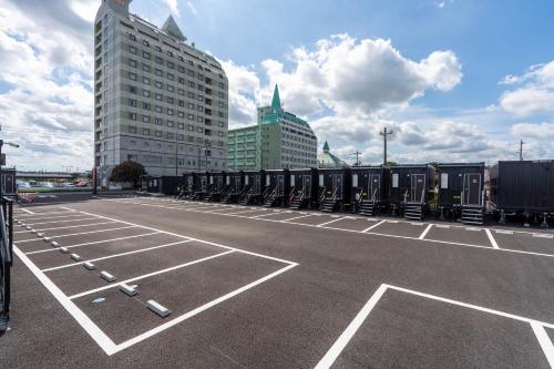 a parking lot with a row of train cars at HOTEL R9 The Yard Kasama in Tomobe
