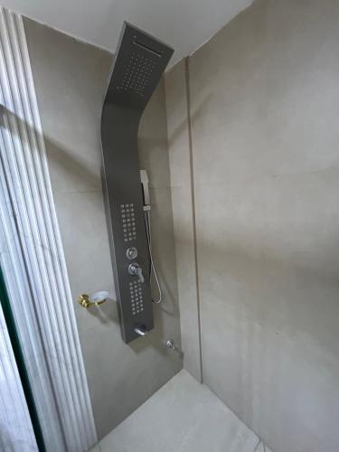 a shower with a phone in the corner of a bathroom at La Gabbanee Hotel Boutique in Fernando de la Mora