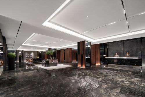 a lobby of a hotel with a reception desk at 上海虹桥中心城际酒店 in Shanghai