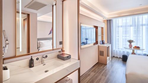 a bathroom with a sink and a mirror at Elong Hotel Beijing Chang'an Tianjie Bridge Huiying Metro Station Branch in Beijing