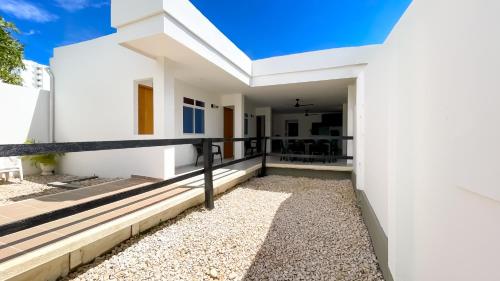 a white house with white walls and a balcony at Habitacion Manglares 101 in Coveñas