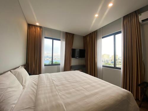 Postel nebo postele na pokoji v ubytování Uông Bí Boutique Hotel
