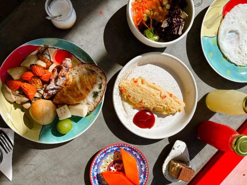 a bunch of plates of food on a table at The Fig Lobby Bangkok in Bangkok