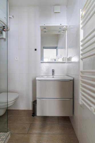 a white bathroom with a sink and a toilet at MARNE - Cosy studio in Menton in Menton