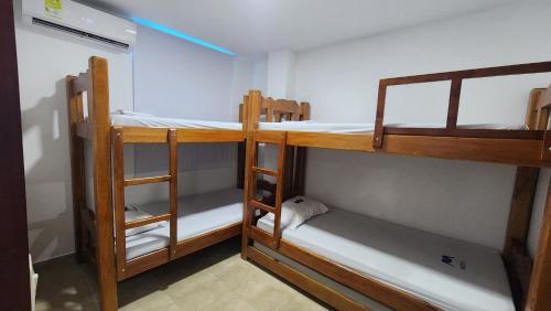 a room with three bunk beds in a room at Cabaña brisa de mar in San Silvestre