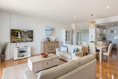 a living room with a couch and a table at Wharf Apartment Unit 5 in Narooma