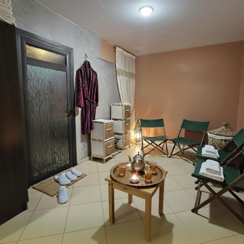 a room with chairs and a table and a door at Villa Lumiere-Luxury Retreat with Private Spa and Garden in Ifrane