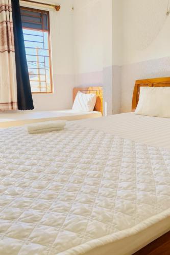 Ένα ή περισσότερα κρεβάτια σε δωμάτιο στο Việt Anh Hotel