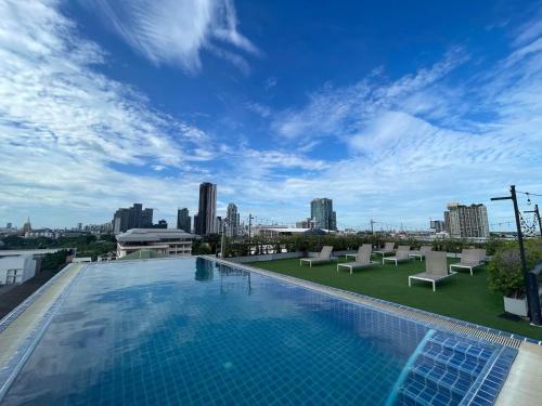 a swimming pool on the roof of a building at Romance Hotel Sukhumvit 97 in Bangkok