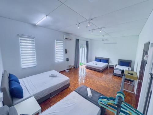 a large room with two beds and a couch at Tanjung Bungah Holiday Home 4BR 20Pax 6Carpark in Tanjung Bungah