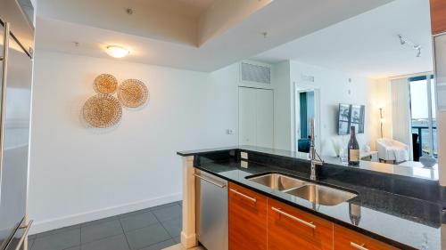 a kitchen with a sink and a counter top at Blue Harbour Amazing views 5 min downtown in Fort Myers