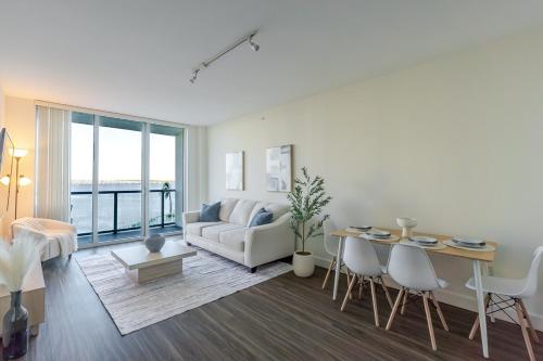 a living room with a couch and a table at Blue Harbour Amazing views 5 min downtown in Fort Myers