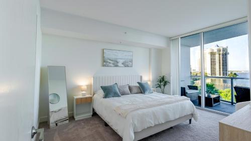 a bedroom with a large bed and a large window at Blue Harbour Amazing views 5 min downtown in Fort Myers