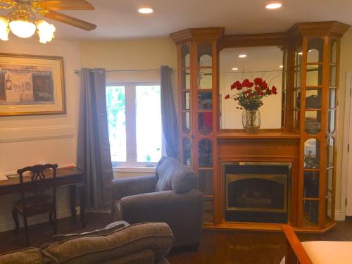 a living room with a couch and a fireplace at Grey Rose Suites in Hanover