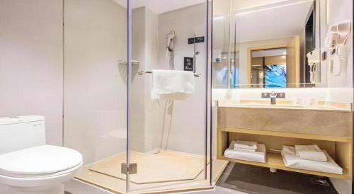 a bathroom with a shower and a toilet and a sink at City Comfort Inn Guangzhou Shisanhang Shangxiajiu Pedestrian Street 1st Branch in Guangzhou