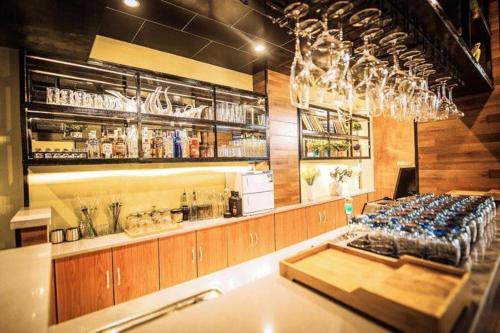 a bar with a row of wine glasses at Immersing Hotel Guilin Two Rivers and Four Lakes Dongxi Alley in Guilin