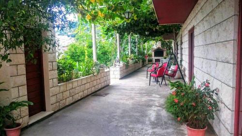 a walkway with chairs and tables on a building at Apartments Radis in Zaton