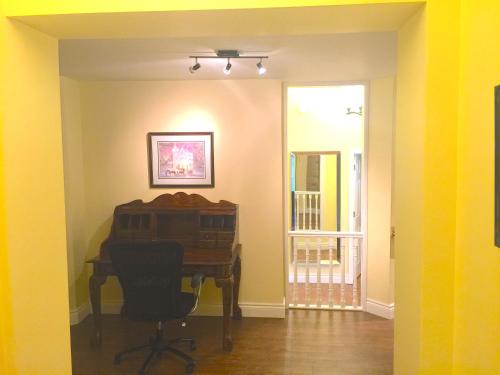 a room with a desk and a chair in it at Grey Rose Suites in Hanover