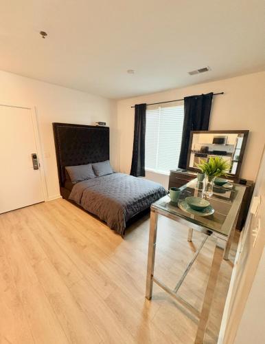 a bedroom with a bed and a glass table at Spacious Studio Living in Kansas City