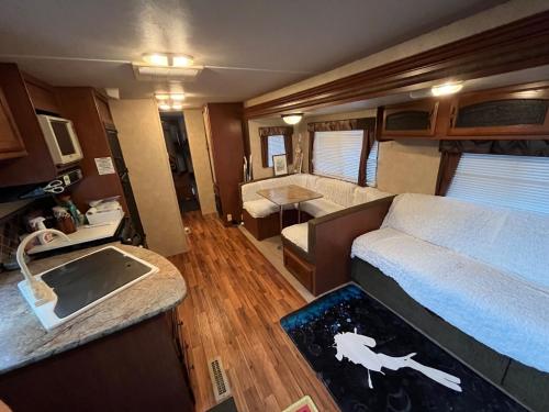 a living room with a bed and a living room with at The Basecamp Yugawara - Vacation STAY 84742v in Miyakami