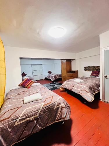 Ένα ή περισσότερα κρεβάτια σε δωμάτιο στο SkyGuest Cusco San Cristobal
