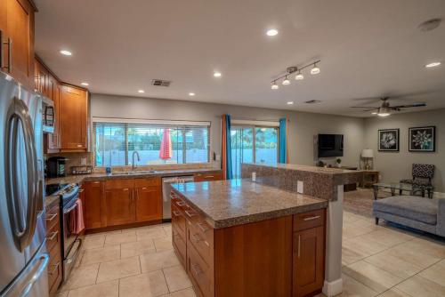 a kitchen with wooden cabinets and a counter top at 3bdr Remodeled Scottsdale Desert Pool Oasis and Entertainment in Phoenix
