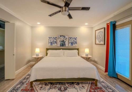 a bedroom with a bed and two tables with lamps at 3bdr Remodeled Scottsdale Desert Pool Oasis and Entertainment in Phoenix