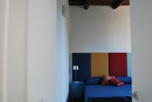 a bedroom with a bed with a blue comforter at B&B Al Dosello in Caserta