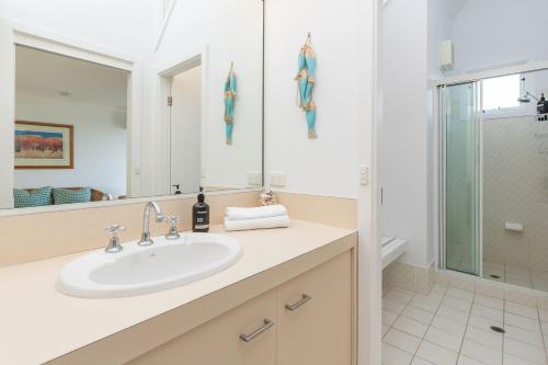 a bathroom with a sink and a shower at Eureka in Boomerang Beach