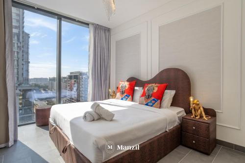 a bedroom with a bed with a large window at Manzil - Luxury 1BR in Sobha Hartland w Pool & Gym Access in Dubai