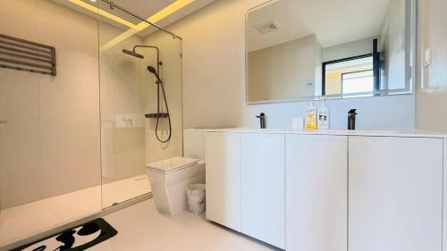a bathroom with a shower and a sink and a toilet at Aura J23A - 8 in Pattaya Central