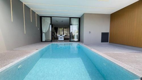 a large blue swimming pool in a building at Aura J23A - 8 in Pattaya Central