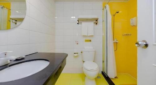 a bathroom with a sink and a toilet and a mirror at Home Inn Hotel Chengdu Gaoshengqiao Subway Station in Chengdu