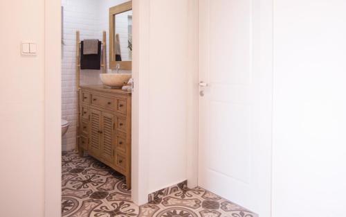 a bathroom with a sink and a vanity with a mirror at Alma in Caesarea