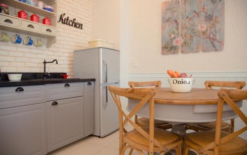 a kitchen with a table and chairs and a refrigerator at Alma in Caesarea