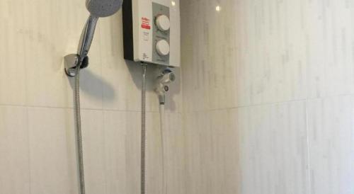 a shower in a bathroom with a shower head at The Royhanna Beach House in Tab Kaek Beach