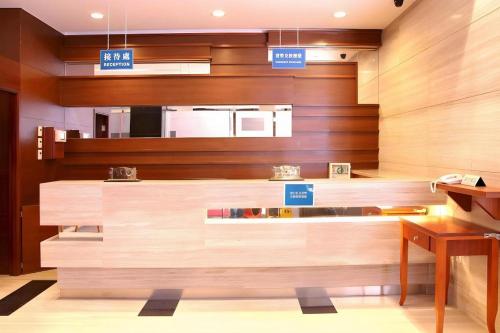 a kitchen with wooden walls with signs on it at Grand Harbour Hotel in Macau