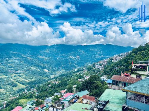 a view of a city with mountains in the background at Dhanishta Delight in Gangtok