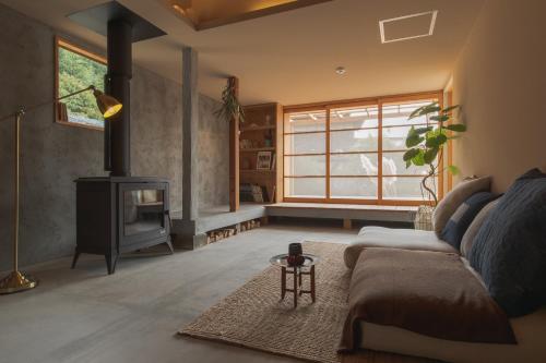 a living room with a couch and a fireplace at La toile in Mitoyo