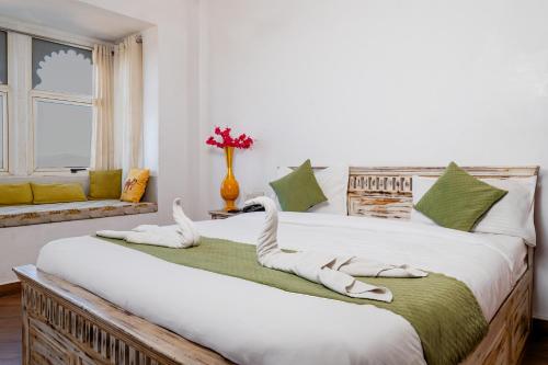 a bedroom with two beds with towels on them at ALBA Mountain Villa's in Chirwa